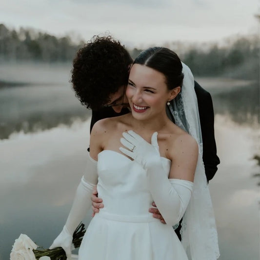 bride wearing long satin gloves with bridal gown