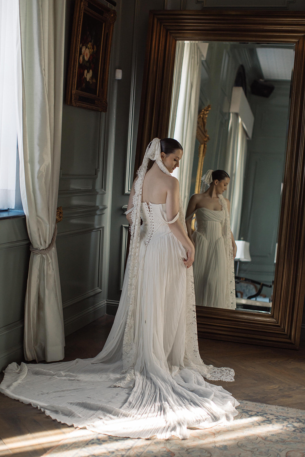 Bride wearing lace bow veil